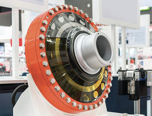 photo of a rotating industrial machine filled with lubrication and on a table in an engineering lab