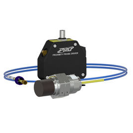 A black 25 mm proximity probe driver with a yellow faceplate, surrounded by a 25 mm proximity probe on a blue extension cable.