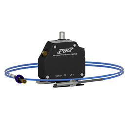 A FFv 5 mm proximity probe driver with a silver faceplate, surrounded by a 5 mm proximity probe on a coiled, blue extension cable.