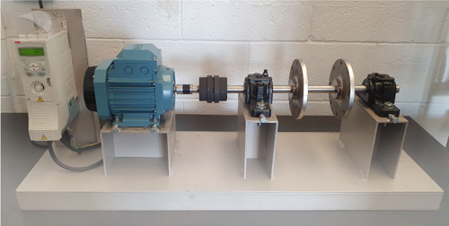 photograph of the trial rig setup including a blue motor and a shaft